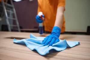 Professional janitor cleaning and desinfecting the tabletop